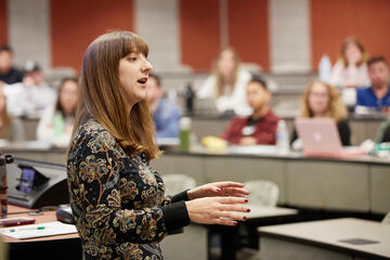 woman speaking at front of classroom to students